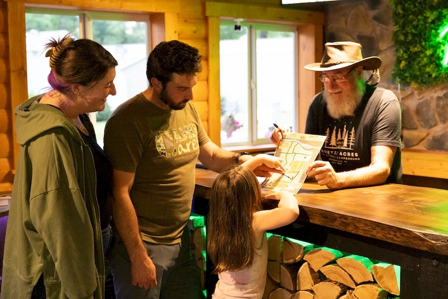 guests checking in at the front desk at rustic acres rv resort and campground
